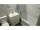 Cozy bathroom highlighting sleek vanity, toilet, tub and shower combo with modern finishes at 1306 Woodbine Dr, Anderson, IN 46011