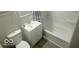 Cozy bathroom highlighting sleek vanity, toilet, tub and shower combo with modern finishes at 1306 Woodbine Dr, Anderson, IN 46011