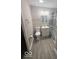 Bathroom featuring a modern toilet, sink, vanity and shower with stylish curtain at 1306 Woodbine Dr, Anderson, IN 46011