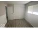 Bedroom featuring gray wood-look flooring, wainscoting, and large closet at 1306 Woodbine Dr, Anderson, IN 46011
