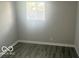 Bedroom featuring gray wood-look flooring and natural light from a window at 1306 Woodbine Dr, Anderson, IN 46011