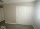 Bedroom with neutral walls, new flooring, closet with sliding doors at 1306 Woodbine Dr, Anderson, IN 46011