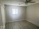 This room has neutral walls, new flooring, ceiling fan and a window with plenty of natural light at 1306 Woodbine Dr, Anderson, IN 46011