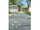 Exterior of the home showcasing a concrete driveway leading to a garage in a landscaped yard at 1306 Woodbine Dr, Anderson, IN 46011
