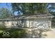 Well-maintained single-story home featuring white trim, attached garage, and meticulous landscaping at 1306 Woodbine Dr, Anderson, IN 46011
