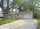 Charming single-story home featuring a well-maintained lawn, a driveway, and a single car garage at 1306 Woodbine Dr, Anderson, IN 46011