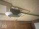 Garage door opener mounted on the ceiling with exposed wiring at 1306 Woodbine Dr, Anderson, IN 46011