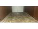 A dimly lit garage with stained concrete floor at 1306 Woodbine Dr, Anderson, IN 46011