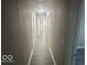Bright hallway with wood-look flooring, white trim, and recessed lighting at 1306 Woodbine Dr, Anderson, IN 46011