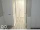 Hallway with gray wood-look flooring, wainscoting, and access to rooms at 1306 Woodbine Dr, Anderson, IN 46011