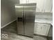 Stainless steel refrigerator with water dispenser and bright white cabinets offers ample storage space at 1306 Woodbine Dr, Anderson, IN 46011