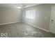 A large living room with vinyl flooring and a window at 1306 Woodbine Dr, Anderson, IN 46011