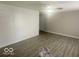 Well-lit living room with vinyl flooring, new white walls, and updated ceiling fan at 1306 Woodbine Dr, Anderson, IN 46011