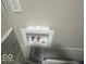 Plumbing features inside the white enclosure at 1306 Woodbine Dr, Anderson, IN 46011