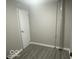 Image featuring a room with a new door, base trim and gray vinyl flooring at 1306 Woodbine Dr, Anderson, IN 46011