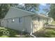 Home featuring vinyl siding, white-framed windows, and well-maintained landscaping at 1306 Woodbine Dr, Anderson, IN 46011
