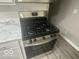 Close-up of modern stainless steel stove oven with digital display and white cabinets at 1306 Woodbine Dr, Anderson, IN 46011