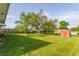 Expansive backyard featuring mature trees, green grass and an outbuilding at 1310 S Catherwood Ave, Indianapolis, IN 46203