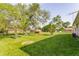 Wide backyard features mature trees, green grass and an outbuilding at 1310 S Catherwood Ave, Indianapolis, IN 46203