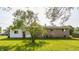 Spacious backyard with a lush green lawn and partial view of the home's exterior at 1310 S Catherwood Ave, Indianapolis, IN 46203