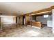 Spacious basement with tiled flooring, wood paneled walls, and a utility area at 1310 S Catherwood Ave, Indianapolis, IN 46203