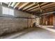 Unfinished basement shows exposed pipes, and block walls at 1310 S Catherwood Ave, Indianapolis, IN 46203