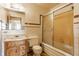 Bathroom with a wooden vanity, standard toilet, and a shower/tub with sliding doors at 1310 S Catherwood Ave, Indianapolis, IN 46203