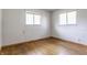 Simple bedroom with hardwood flooring, two windows, and bright light at 1310 S Catherwood Ave, Indianapolis, IN 46203
