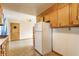 Kitchen with appliances, cabinets, refrigerator, and doorway to other room, showing layout and potential at 1310 S Catherwood Ave, Indianapolis, IN 46203