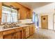 Cozy kitchen featuring wooden cabinets, laminate countertops, and a double stainless steel sink at 1310 S Catherwood Ave, Indianapolis, IN 46203
