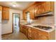 Functional kitchen with wooden cabinets, laminate countertops, and essential appliances at 1310 S Catherwood Ave, Indianapolis, IN 46203