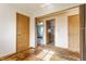 Vacant living room shows wood and carpet flooring with two doorways and 2 closets at 1310 S Catherwood Ave, Indianapolis, IN 46203