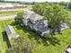 Aerial view showcasing a home with mature trees, green lawns, and additional structures on a spacious lot at 1325 Fordice Rd, Lebanon, IN 46052
