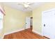 Bedroom with hardwood floors, yellow walls, and white trim with a ceiling fan above at 1325 Fordice Rd, Lebanon, IN 46052