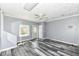 Bedroom features grey vinyl flooring, fan, and neutral colored walls at 1325 Fordice Rd, Lebanon, IN 46052