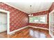 Charming dining room with hardwood floors, decorative wallpaper, and a vintage chandelier at 1325 Fordice Rd, Lebanon, IN 46052