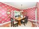 Formal dining room with stylish wallpaper, hardwood floors, and French doors, perfect for hosting dinner parties at 1325 Fordice Rd, Lebanon, IN 46052