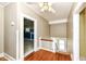 Hallway with hardwood floors leads to bedroom and staircase at 1325 Fordice Rd, Lebanon, IN 46052