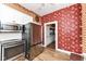 Well-equipped kitchen with stainless steel appliances, white cabinets, and decorative wallpaper at 1325 Fordice Rd, Lebanon, IN 46052