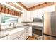 Well-lit kitchen with white cabinets, stainless steel appliances, farmhouse sink, and granite countertops at 1325 Fordice Rd, Lebanon, IN 46052
