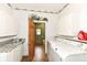 Practical laundry area with countertop space, wooden door, and modern appliances for everyday convenience at 1325 Fordice Rd, Lebanon, IN 46052