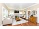 Bright living room featuring hardwood floors, fireplace, and large windows that provide ample natural light at 1325 Fordice Rd, Lebanon, IN 46052