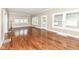 Sunlit living room featuring hardwood floors and multiple windows, enhancing the home's natural light at 1325 Fordice Rd, Lebanon, IN 46052