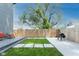 Beautiful backyard with large tree, new patio, and BBQ at 1425 Kennington St, Indianapolis, IN 46225