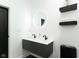 Modern bathroom featuring floating vanity, sleek black fixtures, and round LED mirror at 1425 Kennington St, Indianapolis, IN 46225