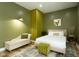 Comfortable bedroom featuring neutral green tones, stylish decor, and soft lighting at 1425 Kennington St, Indianapolis, IN 46225