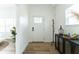 Bright entryway featuring wood floors and a stylish accent cabinet at 1425 Kennington St, Indianapolis, IN 46225