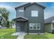 This two-story home features new siding, updated windows, a covered entrance, and modern design at 1425 Kennington St, Indianapolis, IN 46225