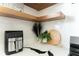 Modern kitchen counter with sleek appliances, stylish decor, and floating wood shelves at 1425 Kennington St, Indianapolis, IN 46225