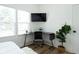 Home office with corner desk setup, ergonomic chair, and leafy green plant at 1425 Kennington St, Indianapolis, IN 46225